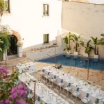 Image of tables at wedding venue with pool in background Masia Victoria
