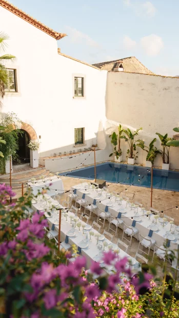 Image of tables at wedding venue with pool in background Masia Victoria