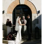 Image of couple getting married at end of aisle at wedding venue Masia Victoria
