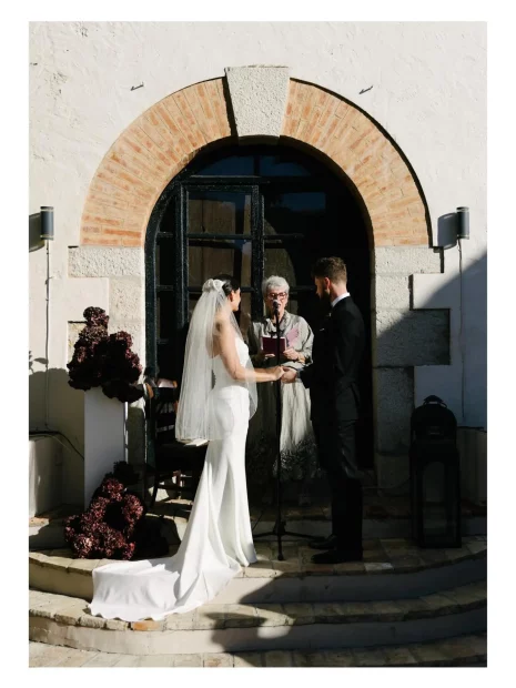 Image of couple getting married at end of aisle at wedding venue Masia Victoria