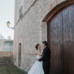 bride and groom outside the brick wall exterior at unique industrial wedding venue colonia rusinol
