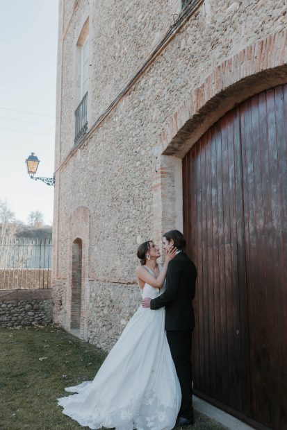 bride and groom outside the brick wall exterior at unique industrial wedding venue colonia rusinol