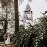 bride and groom wandering through the forest at polish wedding venue the palace osowa sien