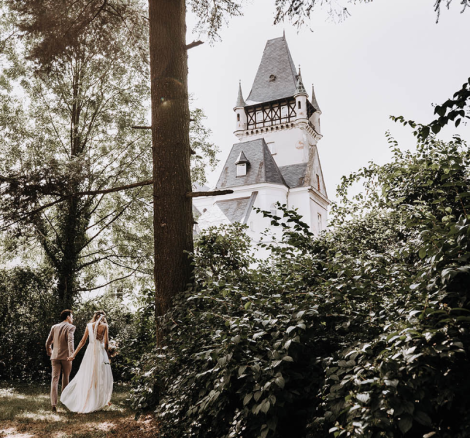 bride and groom wandering through the forest at polish wedding venue the palace osowa sien