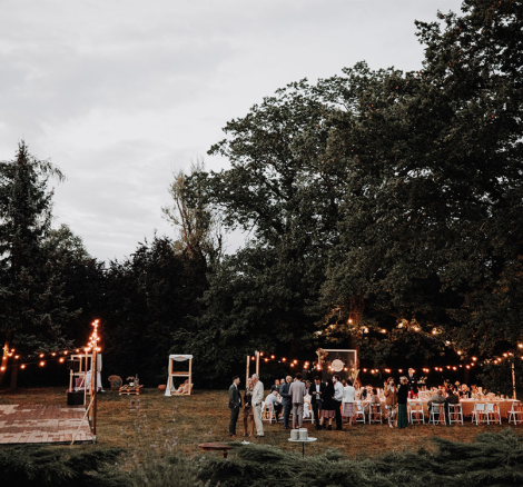 the wedding reception outdoors with fairy lights of polish wedding venue the palace osowa sien