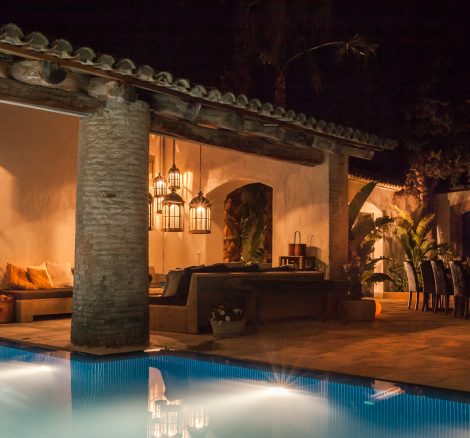 the pool lit up at night by the courtyards outside spanish wedding venue Masia Victoria