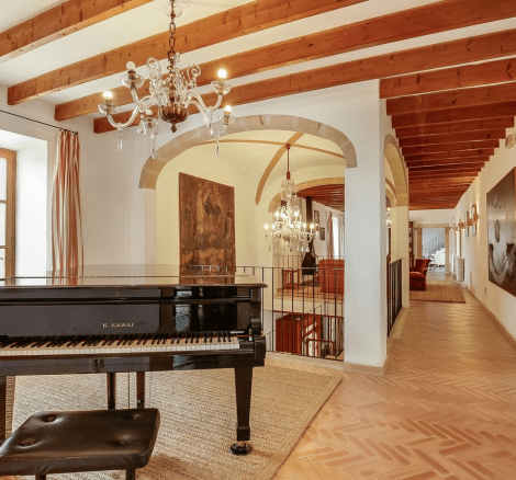 interior of spanish property with black baby grand piano aerial shot above the grounds of son doblons wedding venue in mallorca