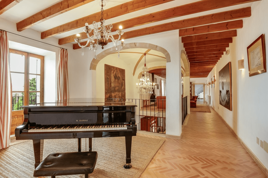 interior of spanish property with black baby grand piano aerial shot above the grounds of son doblons wedding venue in mallorca