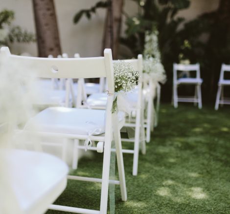 white wooden fold out chairs for wedding ceremony at spanish wedding venue Masia Victoria