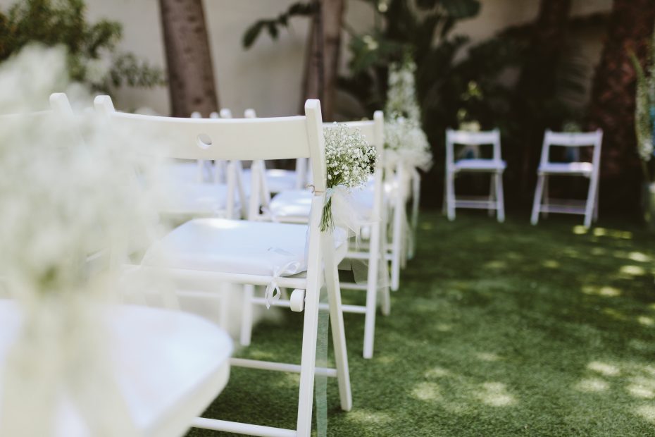 white wooden fold out chairs for wedding ceremony at spanish wedding venue Masia Victoria