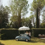Image of little car with umbrella at wedding venue Castello di San Fabiano