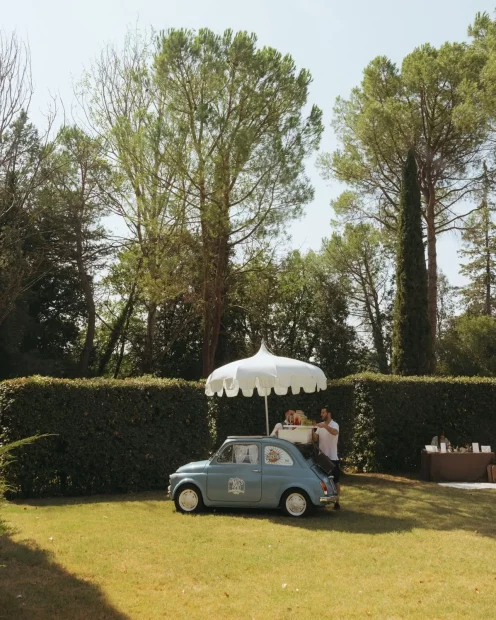 Image of little car with umbrella at wedding venue Castello di San Fabiano