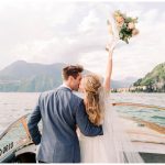 bride and groom on boat on lake como