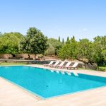 the pool area with surrounding big green olive trees at son doblons spanish wedding venue in mallorca