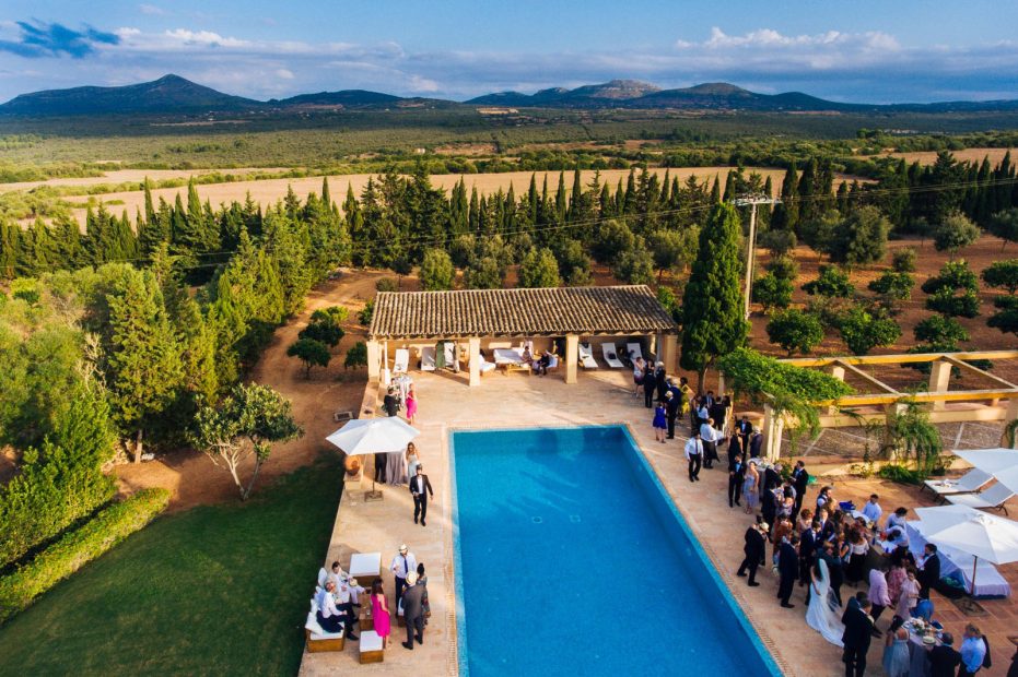 wedding guests surrounding the pool area at Son Doblons wedding venue in mallorca spain