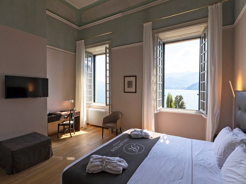 Double bedroom with two large windows that look over Lake Como at Villa Cipressi a unique destination wedding venue