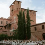 Image of table lay out with wedding venue Castello di San Fabiano in the background