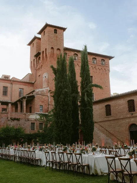 Image of table lay out with wedding venue Castello di San Fabiano in the background