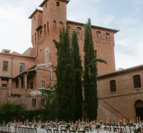 Image of table lay out with wedding venue Castello di San Fabiano in the background