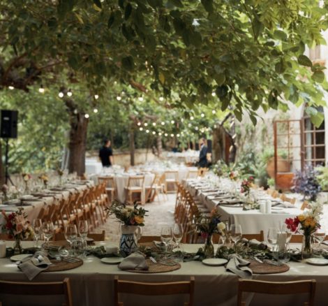 wedding tables set up for al fresco dining beneath the trees at villa Catalina in spain