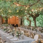 long rectangular wedding tables with grey linens and wooden chairs at villa Catalina in spain