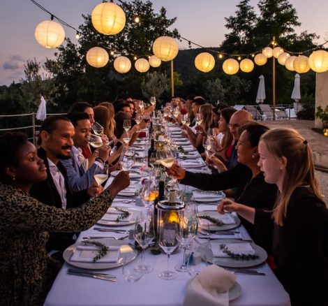 wedding guests cheers-ing during wedding breakfast at sundown