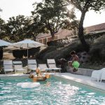 wedding guests lounging in and around pool area at Italian country estate