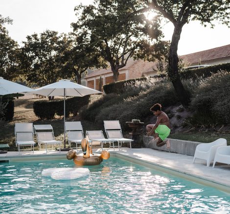 wedding guests lounging in and around pool area at Italian country estate