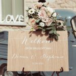 wedding sign lent up against a blue tuk tuk at Italian wedding venue in Marche