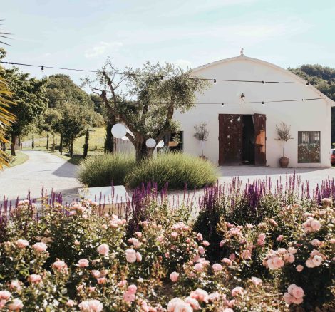 beautiful country estate wedding venue in Italy with pink flowers and shrubs outside