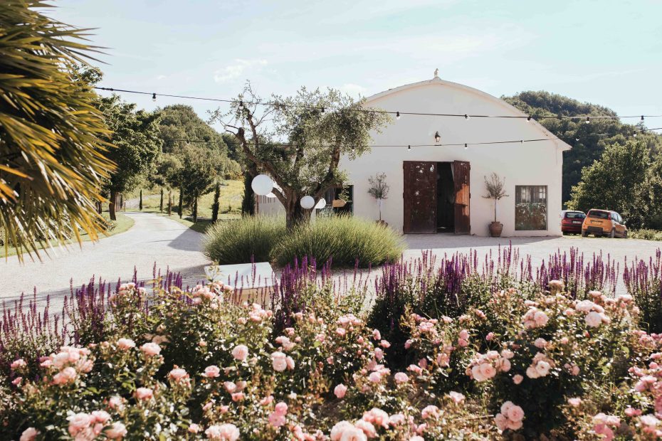 beautiful country estate wedding venue in Italy with pink flowers and shrubs outside