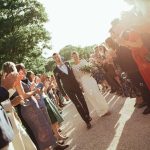 bride and groom walking through their wedding guests post ceremony