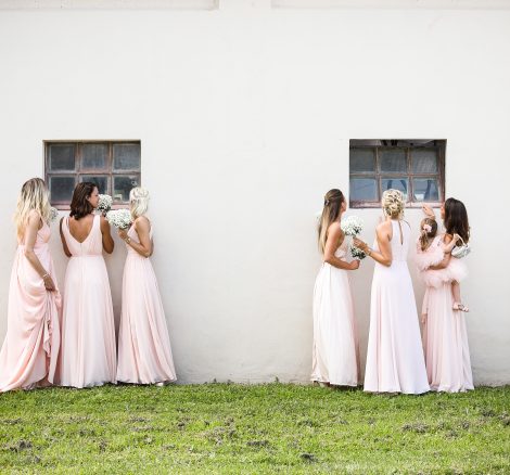 Bridesmaids sneakily looking through the windows at Italian country estate wedding venue