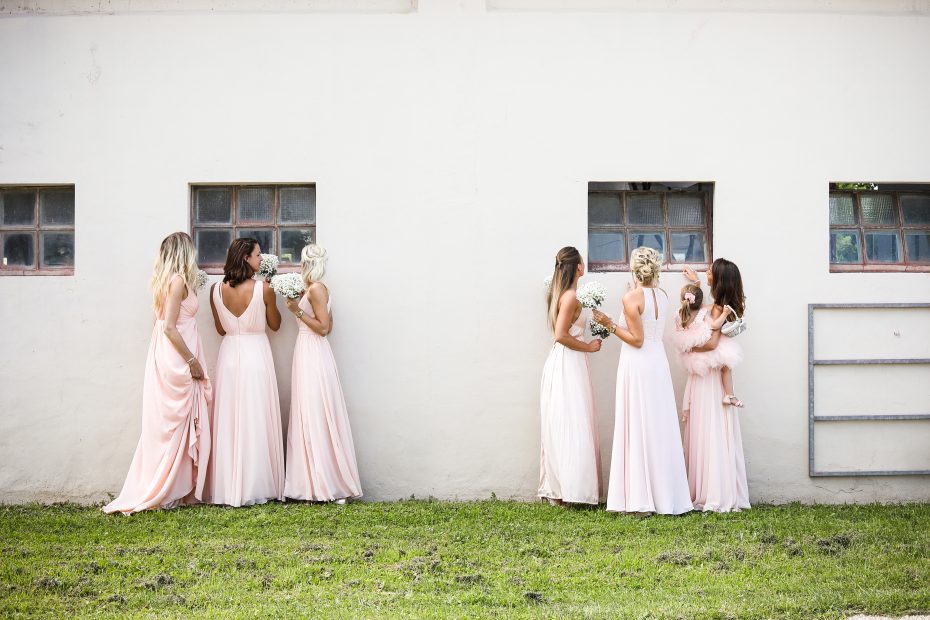 Bridesmaids sneakily looking through the windows at Italian country estate wedding venue