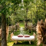 pampas grass by the lake and boho sofa seat at Italian wedding venue convento dell'Annunciata