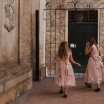 Two little bridesmaids just before walking down the aisle for the ceremony at Italian country house wedding venue