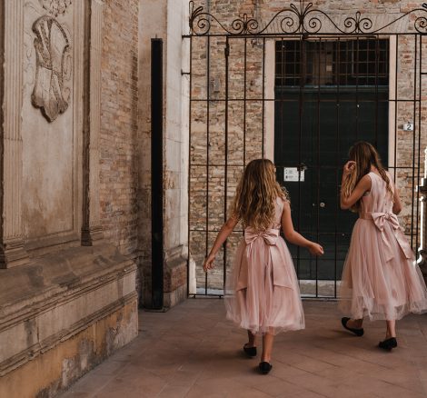 Two little bridesmaids just before walking down the aisle for the ceremony at Italian country house wedding venue