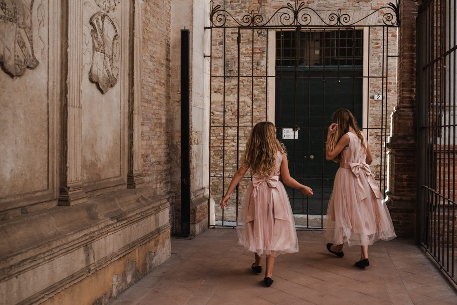 Two little bridesmaids just before walking down the aisle for the ceremony at Italian country house wedding venue