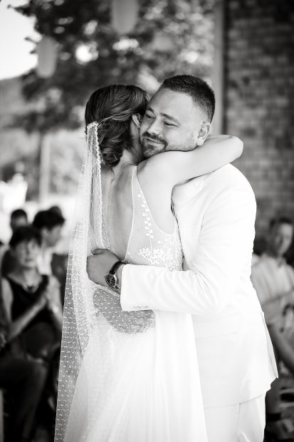 Bride and Groom embracing during wedding ceremony at Italian wedding venue