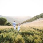 Bride and Groom walking through Italian fields