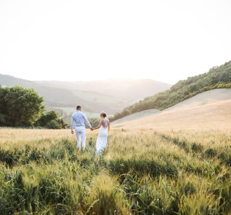 Bride and Groom walking through Italian fields