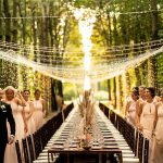 fairy lights strung over long rectangular dining table in the forest at Italian wedding venue convento dell'Annunciata