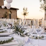 wedding tables with rosemary decoration and white napkins