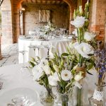 wedding tables with white linen and white flowers at Italian wedding venue Antico convento i cappuccini di montalcino