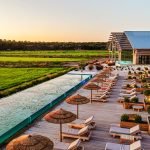 rectangular swimming pool with decking area and loungers at Portuguese wedding venue