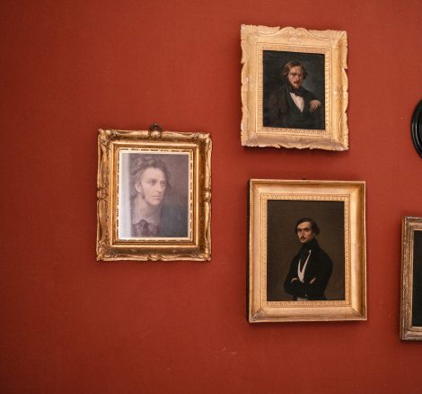red wall with five antique photo frames at Italian wedding venue