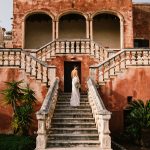 bride walking up the stairs with bridal bouquets down by her side at Italian wedding venue masseria spina