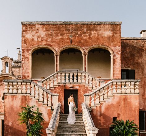 bride on the outer steps at wedding venue in Italy masseria spina