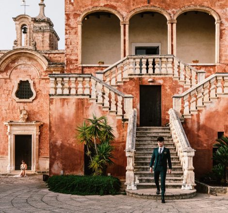 groom walking down from the front steps at Italian wedding venue masseria spina