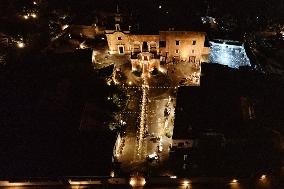 aerial view at night with fairy lights hung over the dining tables at Italian wedding venue masseria spina
